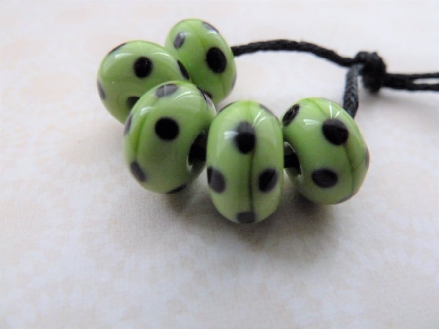 green and black polka dot handmade lampwork glass beads