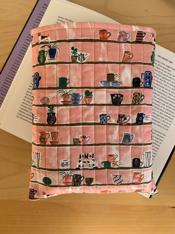 Shelves With Trinkets And Dogs Print Quilted Fabric Book Sleeve - Hardback Size