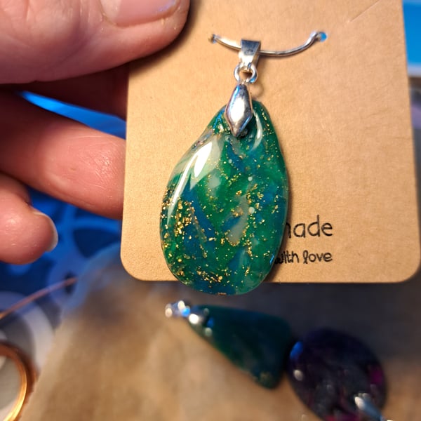 Dark green, blue, white and gold flecked  oval pendant