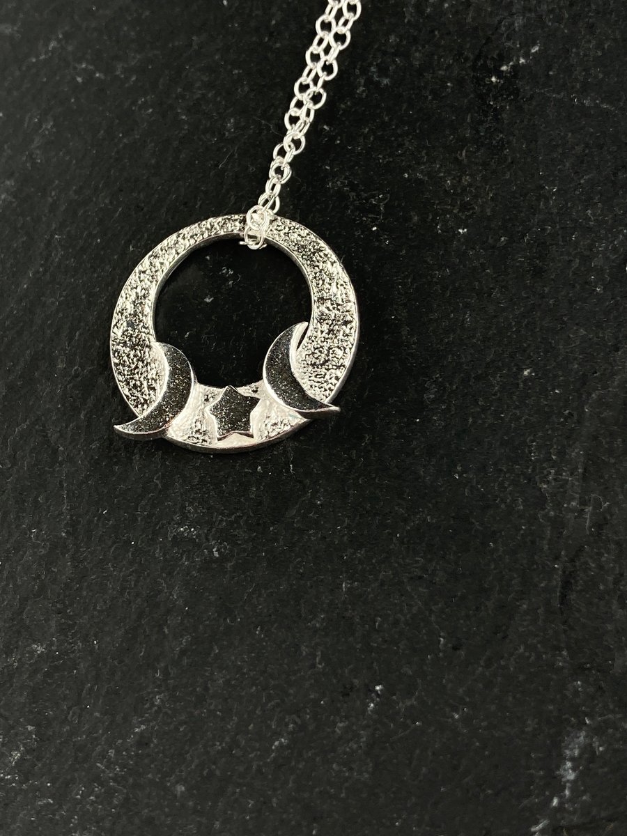 Silver circular moon and stars pendant