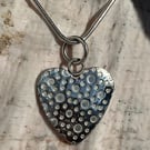 Silver heart pendant with bubbles texture