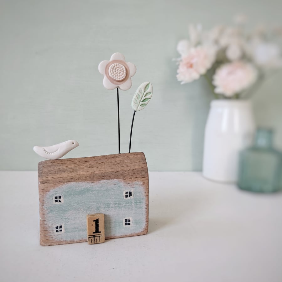 Little Wooden House with Clay Flower and Bird
