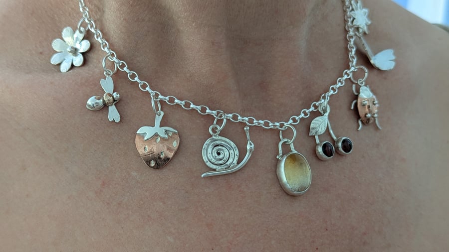 Handmade sterling silver charm necklace with gold, copper and gemstones