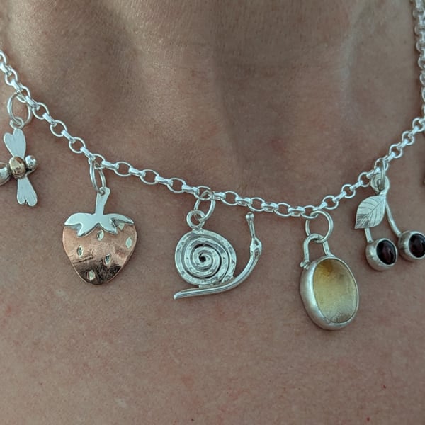 Handmade sterling silver charm necklace with gold, copper and gemstones