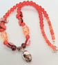 Silver Skull Pendant on an Orange Red Purple & Pink Shell Beaded Necklace - Image 10