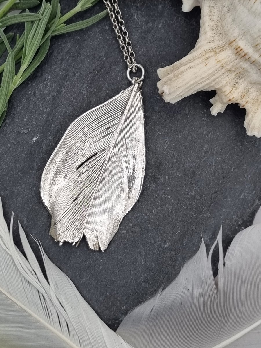 Real feather preserved in silver pendant necklace