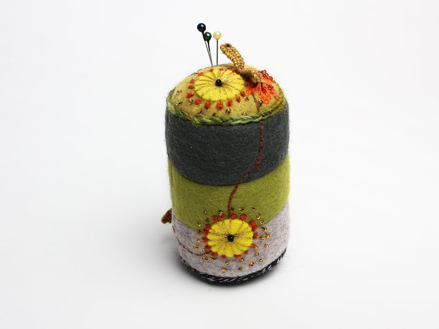 Cylindrical felt pincushion with almond blossom embroidery