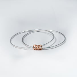 Camila by Fedha - simple pair of silver bangles held together by a copper coil