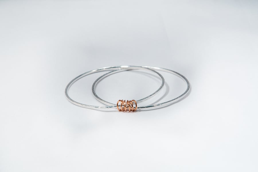 Camila by Fedha - simple pair of silver bangles held together by a copper coil