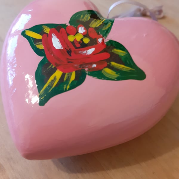 Pink heart shaped bauble with canal art style rose and daisy