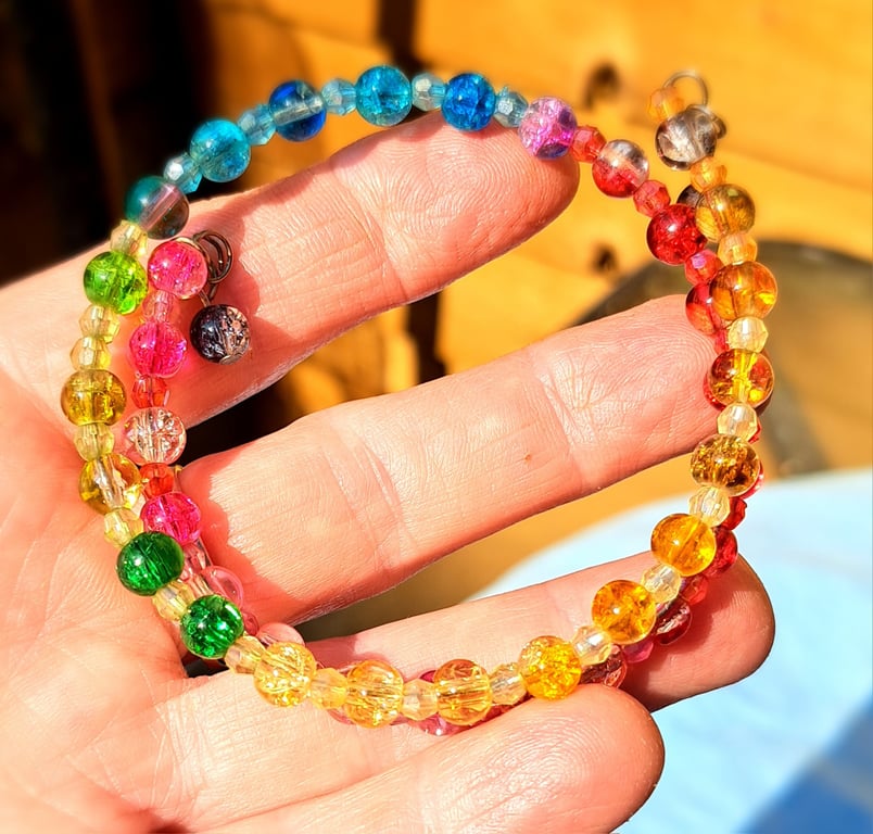 Rainbow beaded double wire bracelet with two hanging beads to finish