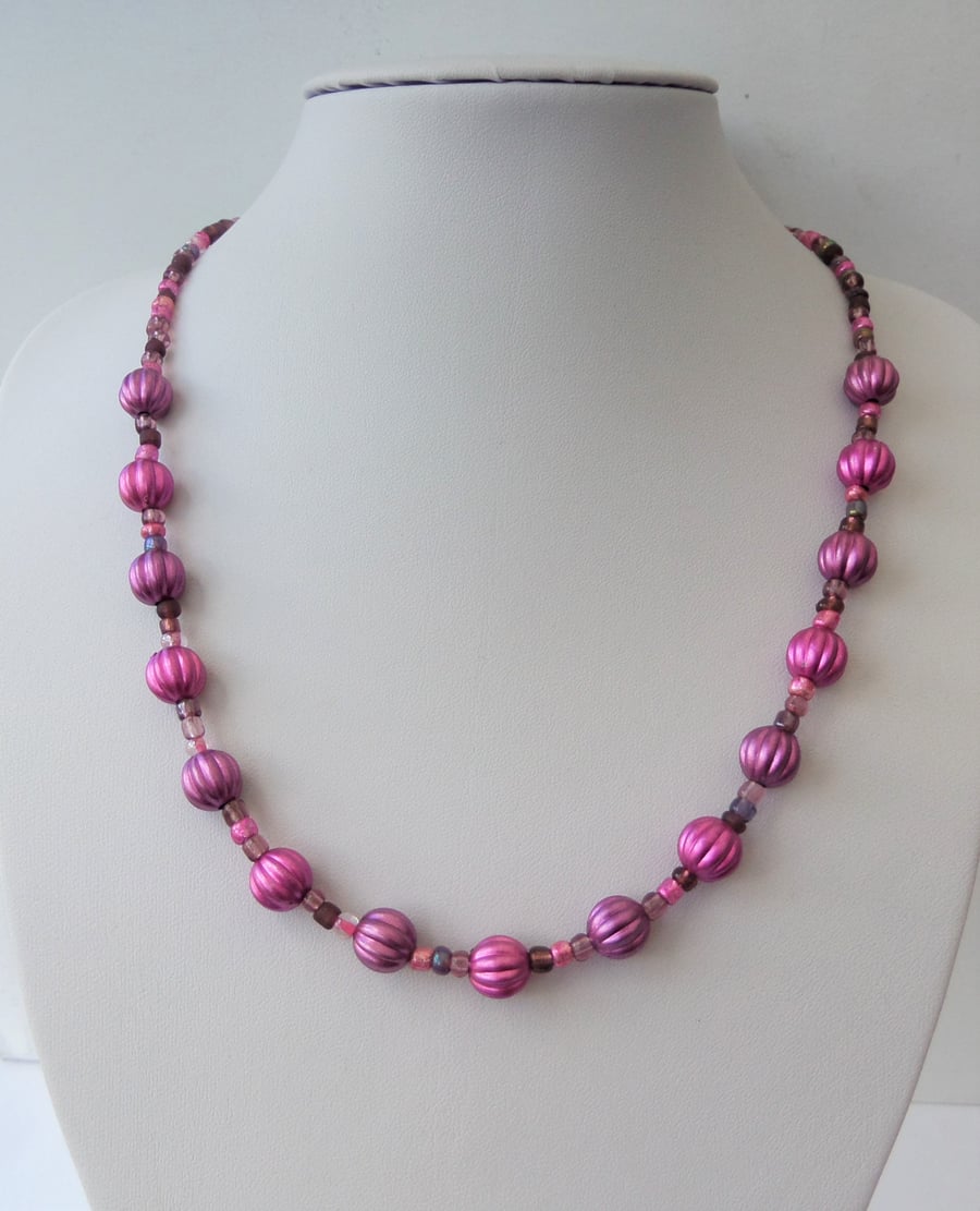 Purple puffed melon and mixed seed bead necklace.