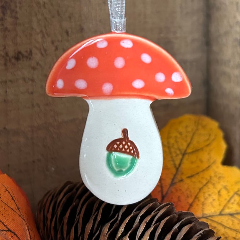 Dark orange ceramic toadstool decoration with acorn detail