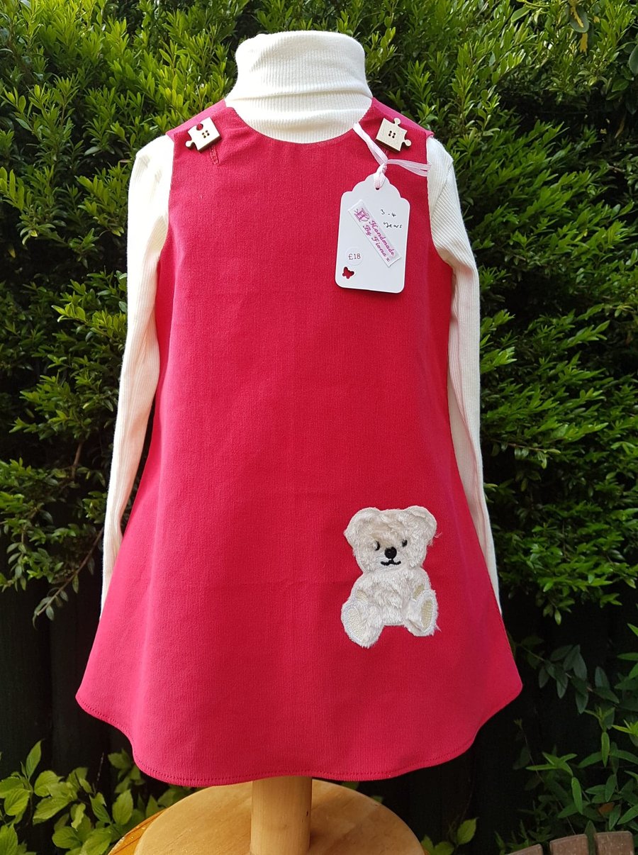 Age: 3-4y. Red baby needlecord pinafore dress. 