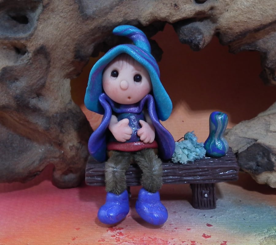 Tiny seated Gnome 'Conn' with wired legs on bench seat OOAK by Ann Galvin