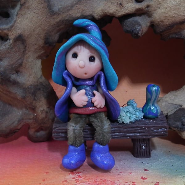 Tiny seated Gnome 'Conn' with wired legs on bench seat OOAK by Ann Galvin