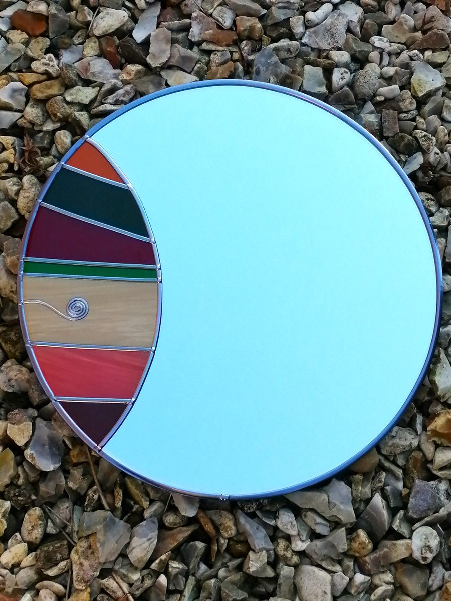 Relish is a 30cm Round Stained Glass Effect Wall Mirror