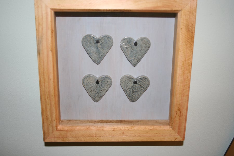 Wooden frame with hand made ceramic small blue textured valentine hearts