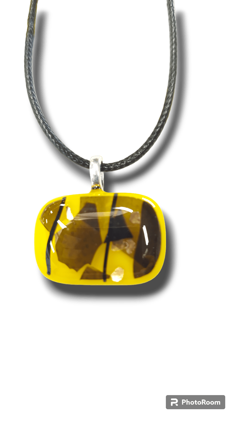 Fused glass pendant that shines yellow with black as a contrast. Unique 