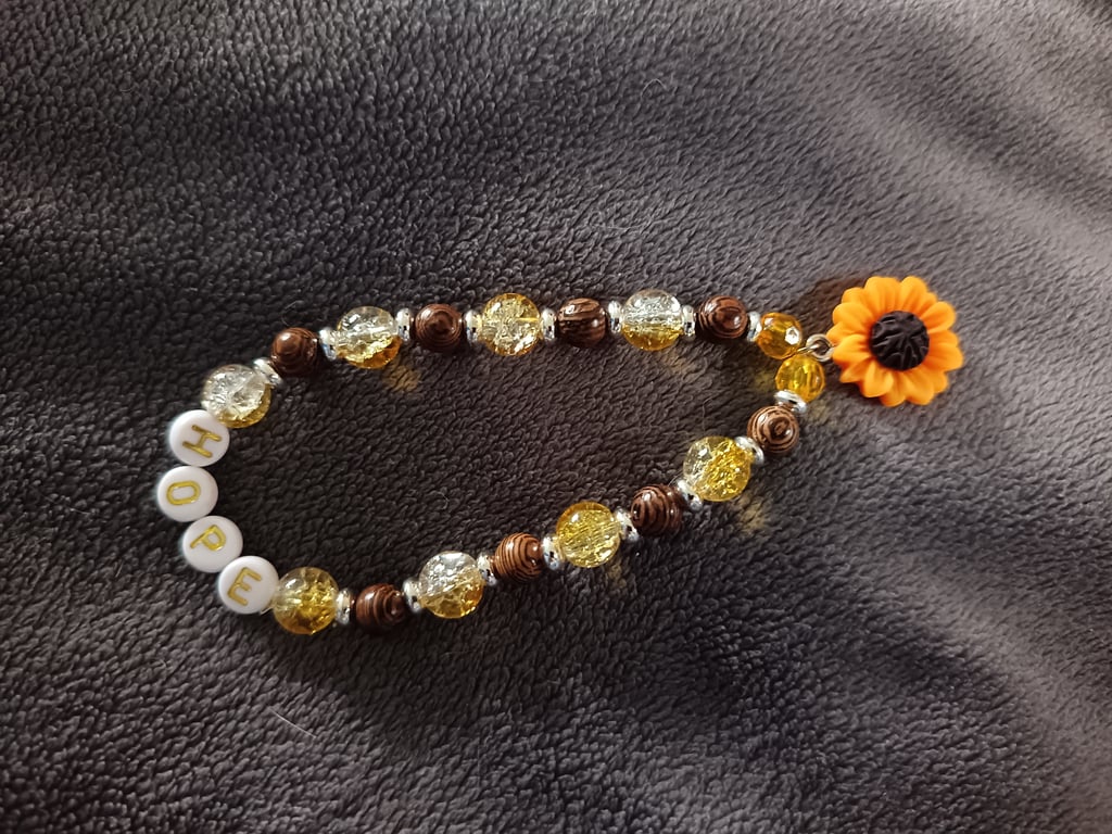 Elasticated "hope" bead bracelet with sunflower charm