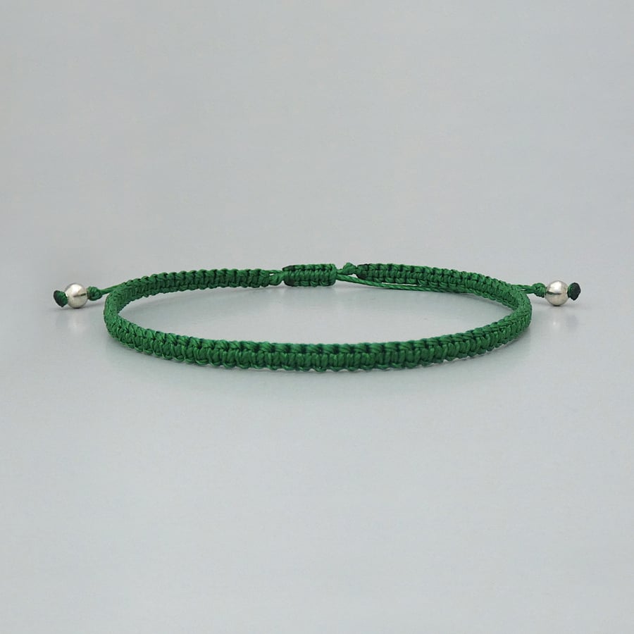 Green macramé bracelet with silver plated bead ends. Extends from 7” to 9.5