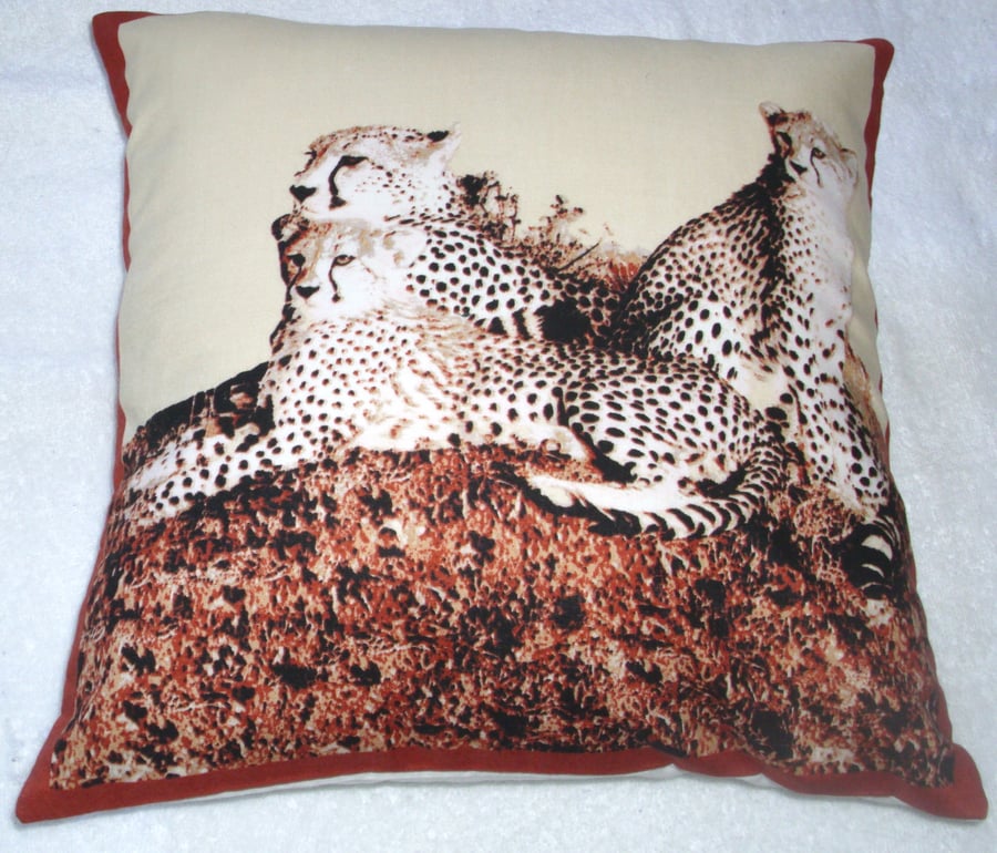 On Safari Leopard lying with her two cubs watching cushion