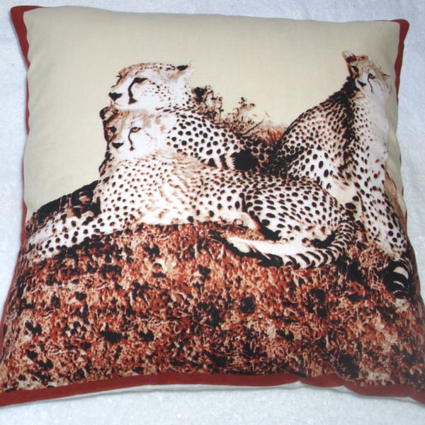 On Safari Leopard lying with her two cubs watching cushion