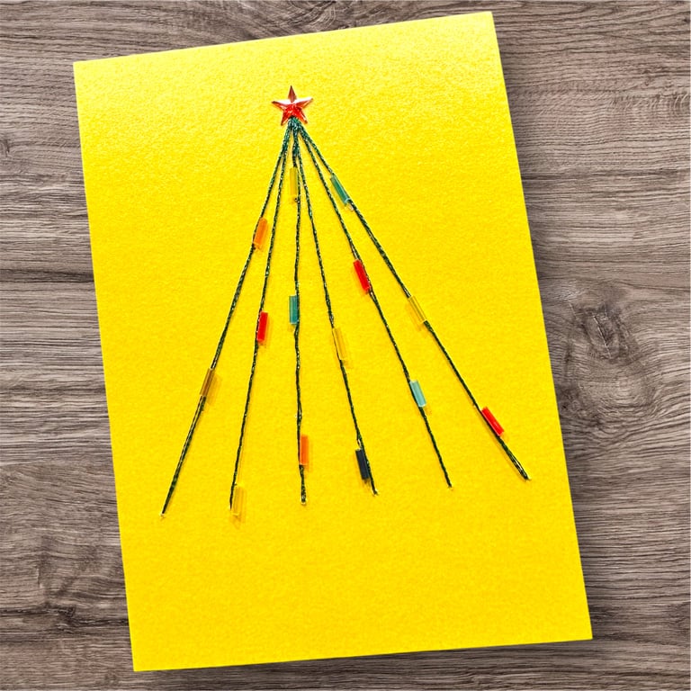 Hand embroidered Christmas card with tree, baubles and red star. Modern bright