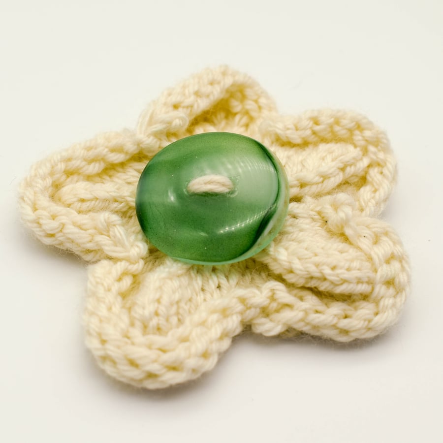 Hand knitted cream flower brooch pin with green fused glass button