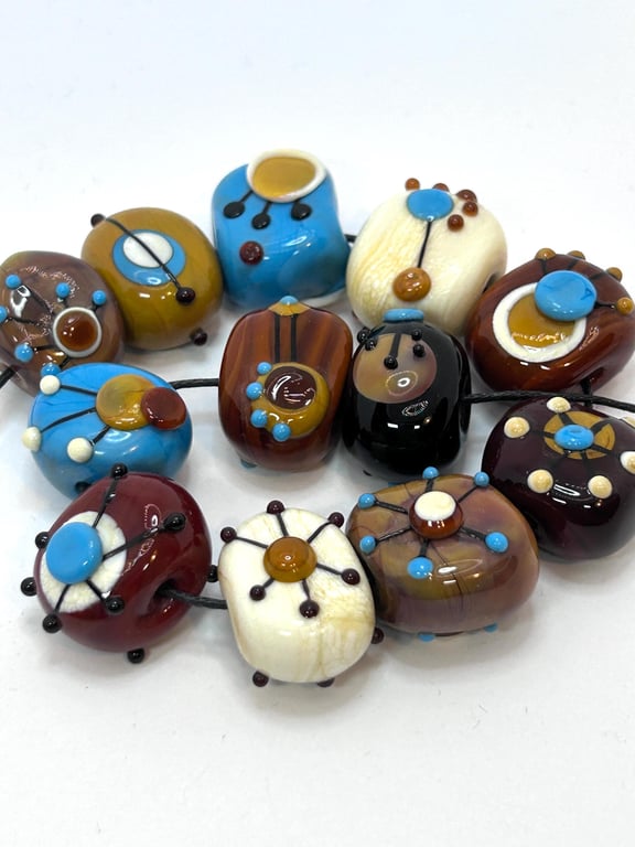 Handmade brown, ivory and turquoise patterned lamp work glass beads