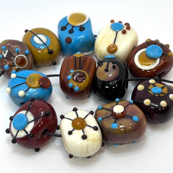 Handmade brown, ivory and turquoise patterned lamp work glass beads