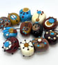 Handmade brown, ivory and turquoise patterned lamp work glass beads - Image 1