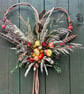 Hazel heart decorated with dried flowers and grasses