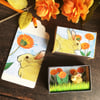 Matchbox art. Diorama - Golden rabbit and marigolds.