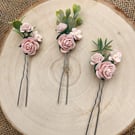 Blush pink flower hair pins, ideal for a wedding.