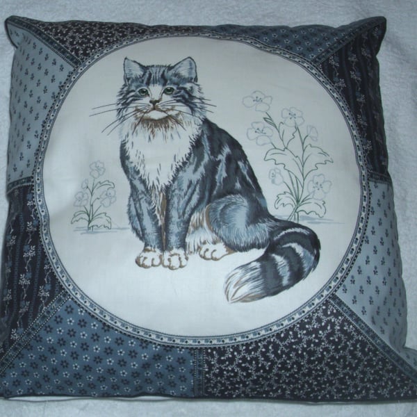 A very pretty grey and white fluffy cat cushion