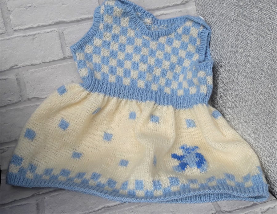 Knitted baby pinafore dress with teddy bear detail