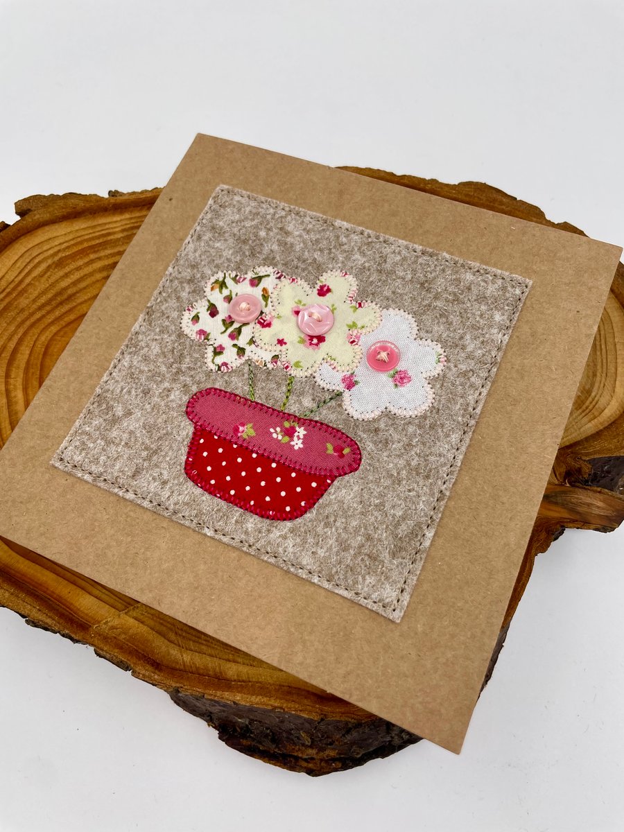 A bowl of appliqué flowers stitched on a card for any occasion