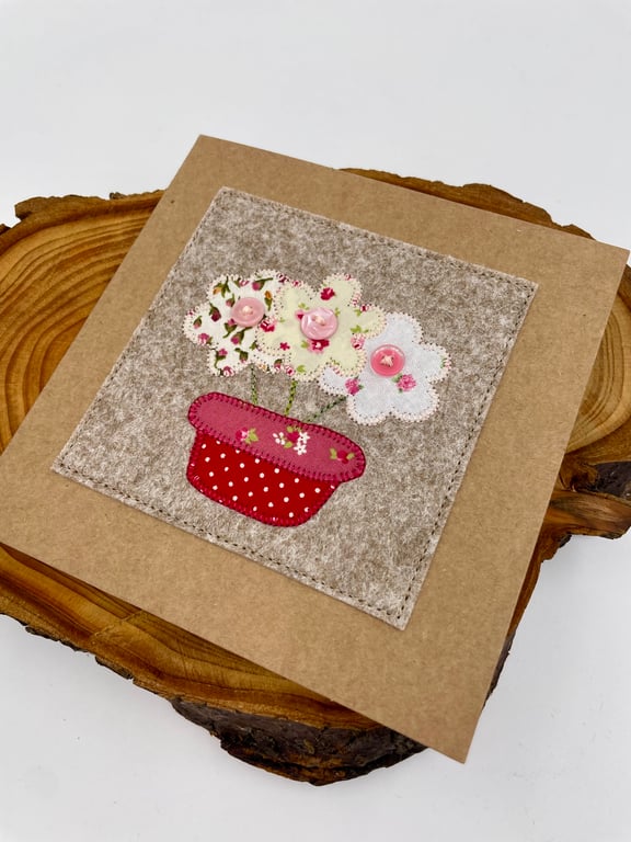 A bowl of appliqué flowers stitched on a card for any occasion