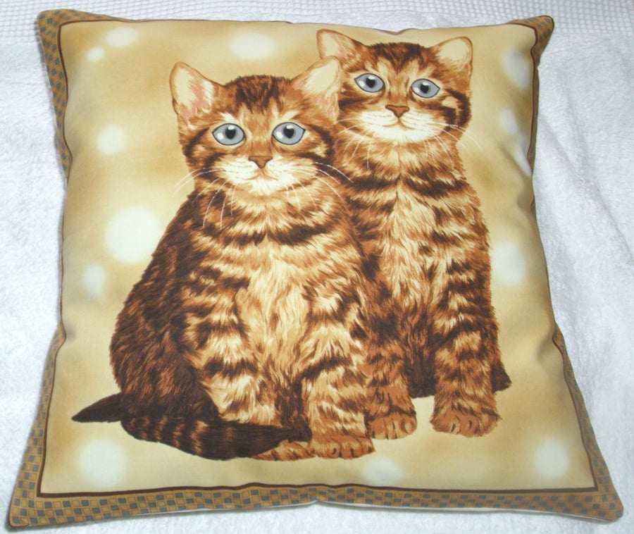 Two pretty Ginger Tabby  Kitties sitting together cushion