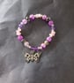 Elasticated pastel goth beaded bracelet with skull and butterfly charm - Image 5