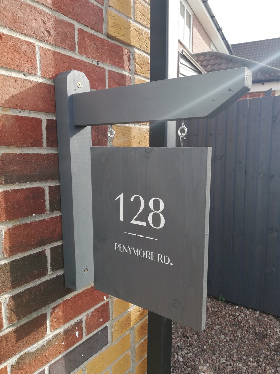 Handmade customisable hanging house name and number sign.