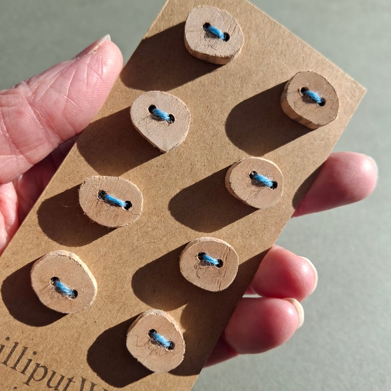 Set of eight small flat driftwood buttons