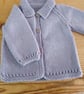 Baby cardigan handmade in lavender merino wool for 3-6 months.