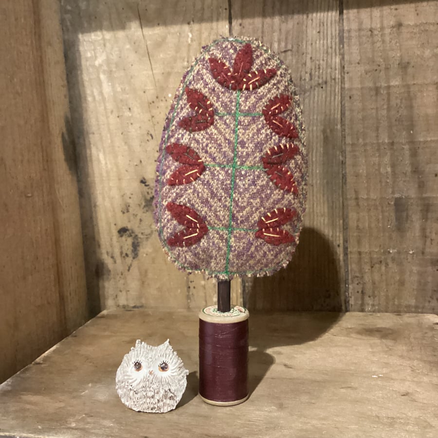 Rust brown tweed tree with dark red leaves