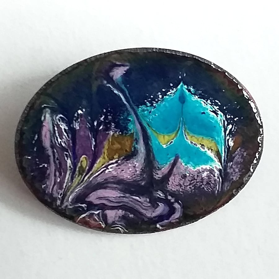 Enamelled copper brooch, purple and blue scrolled over dark blue