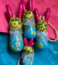A family of 4 wooden colourful bunnies 