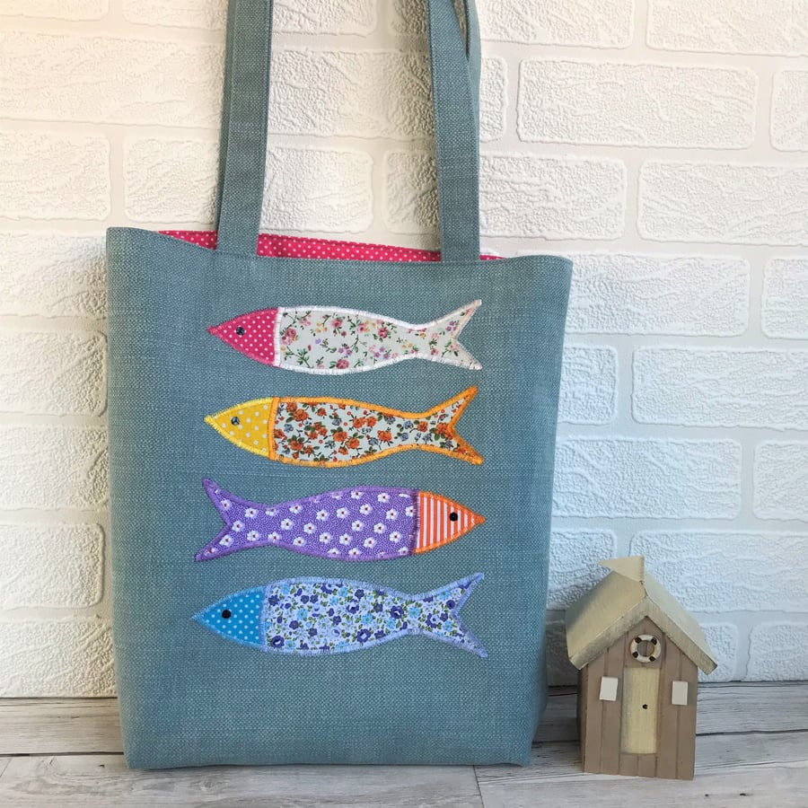 Fish tote bag in blue with four colourful floral fish
