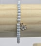 Pearl blue seed bead bracelet with small white flower charm - Image 2