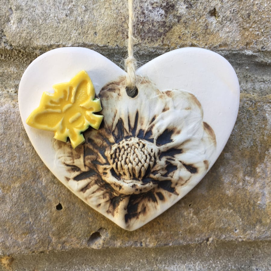 Pottery heart decoration with natural flower design and bee